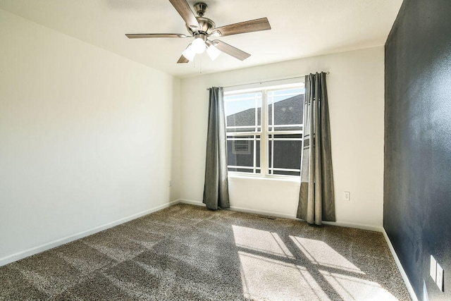 unfurnished room featuring dark colored carpet and ceiling fan