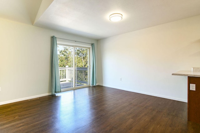 spare room with dark hardwood / wood-style flooring