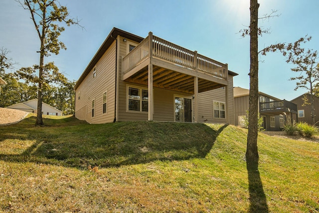 rear view of property featuring a lawn