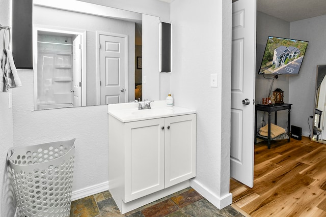 bathroom with hardwood / wood-style flooring and vanity