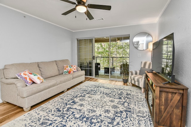 living room featuring crown molding, ceiling fan, and wood-type flooring