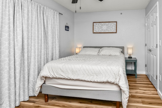 bedroom with ceiling fan and hardwood / wood-style floors