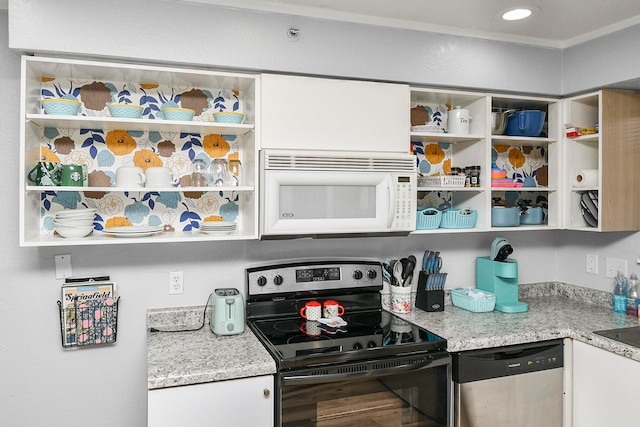 kitchen with light stone countertops, white cabinetry, and stainless steel appliances