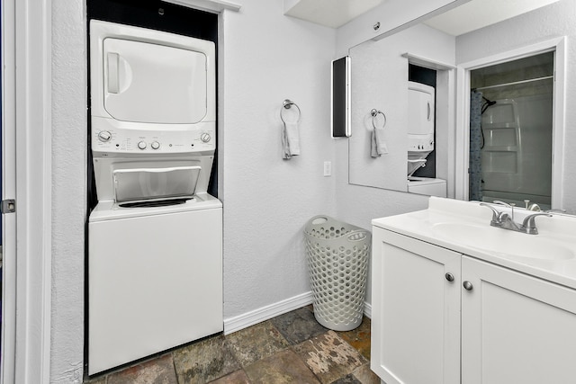 bathroom with stacked washer and clothes dryer and vanity