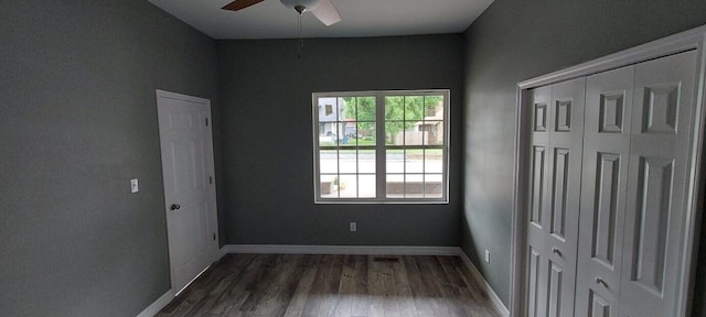 unfurnished bedroom featuring dark hardwood / wood-style floors and ceiling fan