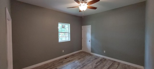 empty room featuring ceiling fan and light hardwood / wood-style flooring