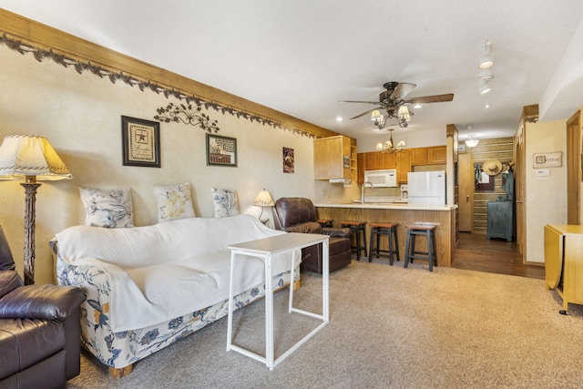 carpeted living room with ceiling fan