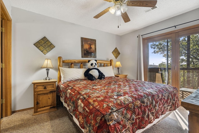 carpeted bedroom with ceiling fan and a textured ceiling