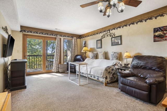 bedroom with a textured ceiling, carpet flooring, ceiling fan, and access to outside