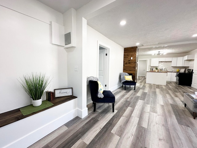 interior space with light hardwood / wood-style flooring and a textured ceiling