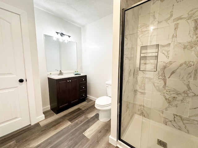 bathroom featuring walk in shower, a textured ceiling, hardwood / wood-style flooring, and toilet