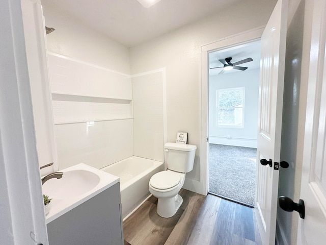 full bathroom with toilet, washtub / shower combination, hardwood / wood-style flooring, vanity, and ceiling fan