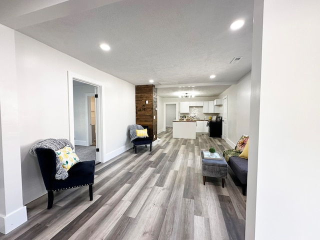 sitting room with a textured ceiling and light hardwood / wood-style flooring