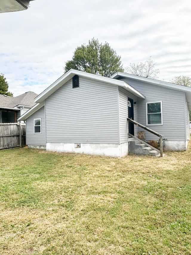 view of property exterior featuring a lawn