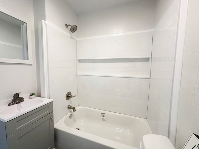 full bathroom with toilet, vanity, and tiled shower / bath