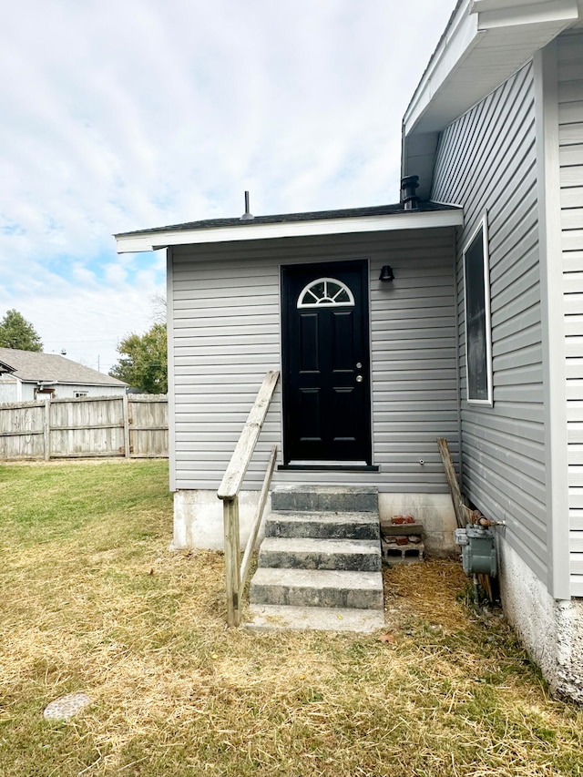 doorway to property with a yard