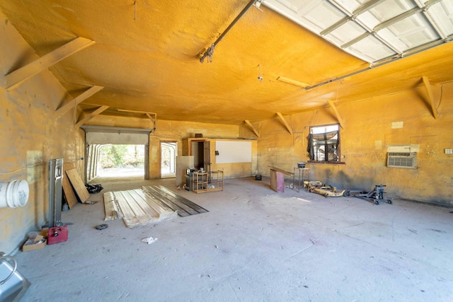 interior space with an AC wall unit and concrete floors