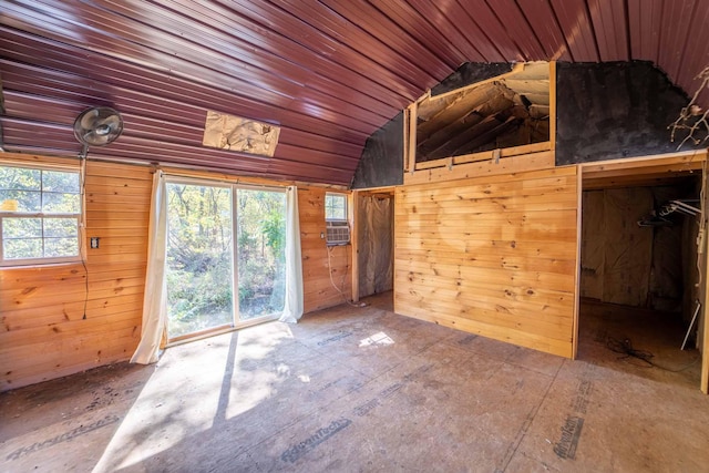 interior space with wood ceiling, wood walls, and vaulted ceiling