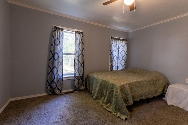 carpeted bedroom with ceiling fan, crown molding, and multiple windows