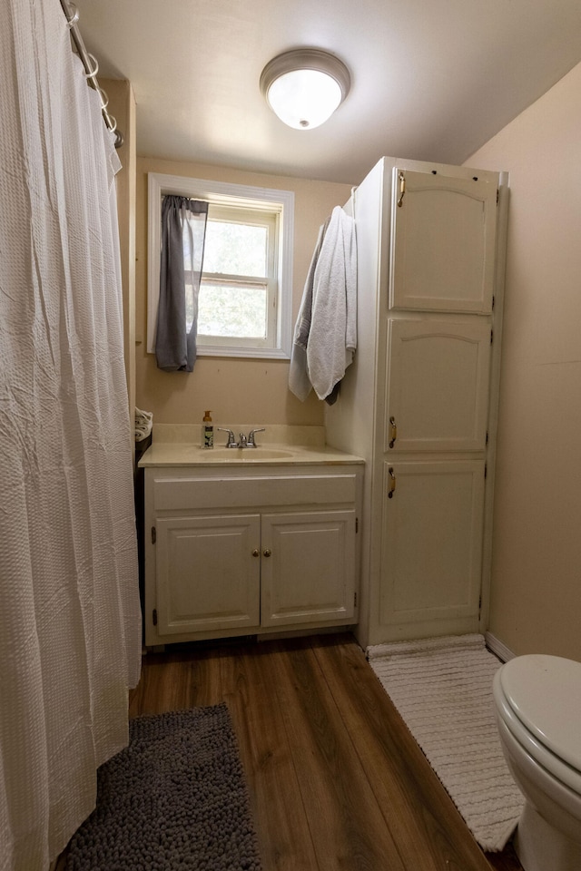 bathroom with vanity, hardwood / wood-style floors, toilet, and a shower with shower curtain