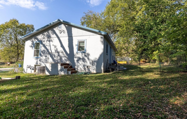 view of side of property with a yard