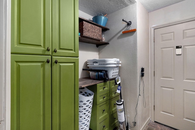 washroom with wood-type flooring and a textured ceiling