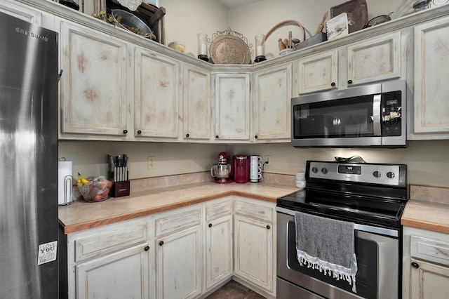 kitchen featuring cream cabinets and stainless steel appliances