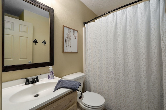 bathroom with vanity, toilet, a textured ceiling, and a shower with shower curtain