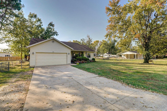 single story home featuring a garage and a front lawn