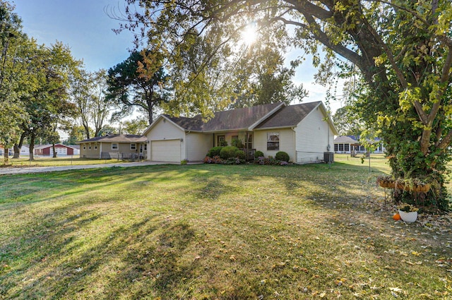 single story home featuring central air condition unit, a garage, and a front yard