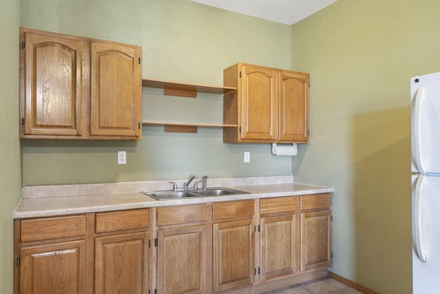 kitchen with sink and white fridge