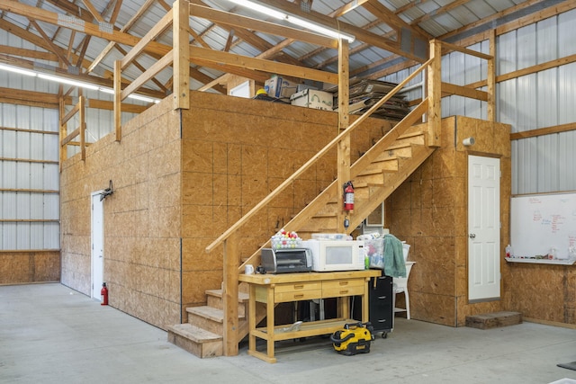 interior space with high vaulted ceiling and concrete floors