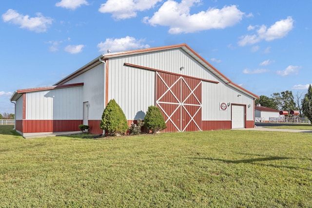 view of outdoor structure with a yard and a garage