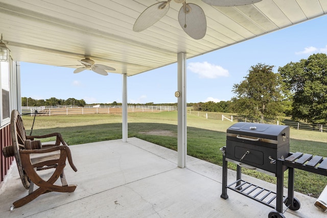 view of patio / terrace featuring ceiling fan and a rural view