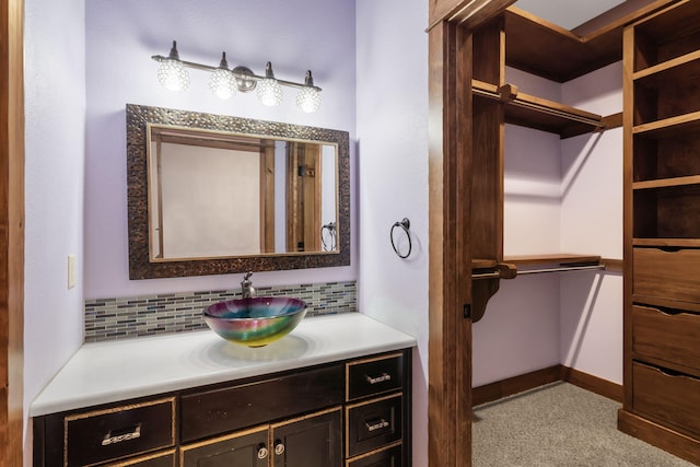 bathroom with vanity and decorative backsplash