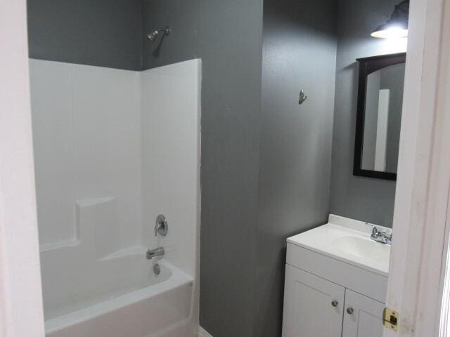 bathroom featuring tub / shower combination and vanity