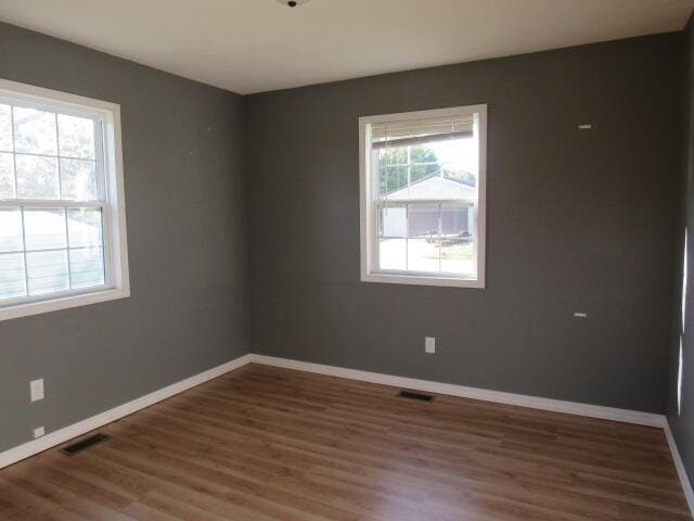 unfurnished room featuring dark hardwood / wood-style floors