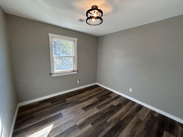 empty room with dark hardwood / wood-style floors