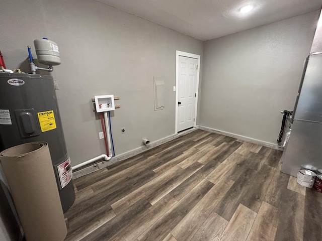 clothes washing area featuring electric water heater, hookup for a washing machine, dark wood-type flooring, and electric dryer hookup