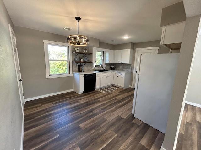 kitchen featuring dark wood-type flooring, dishwasher, white cabinets, sink, and white fridge