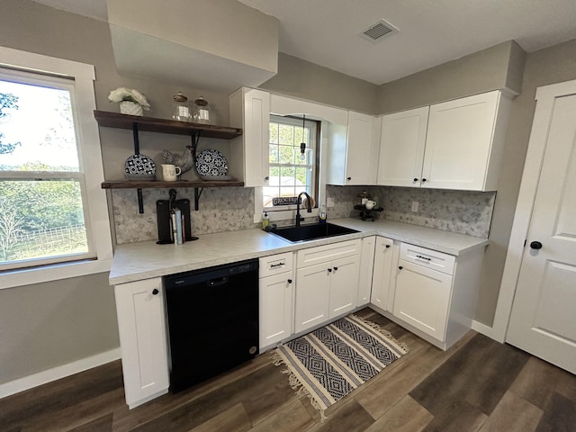 kitchen featuring black dishwasher, a wealth of natural light, white cabinetry, and sink