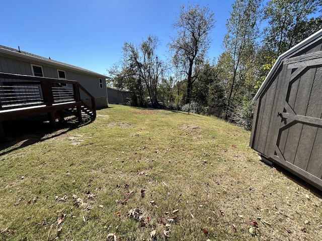 view of yard with a storage shed and a wooden deck