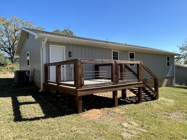 rear view of house with central AC, a yard, and a deck