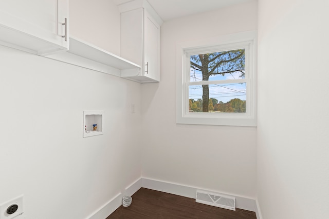 washroom featuring cabinets, hookup for a washing machine, dark wood-type flooring, and electric dryer hookup