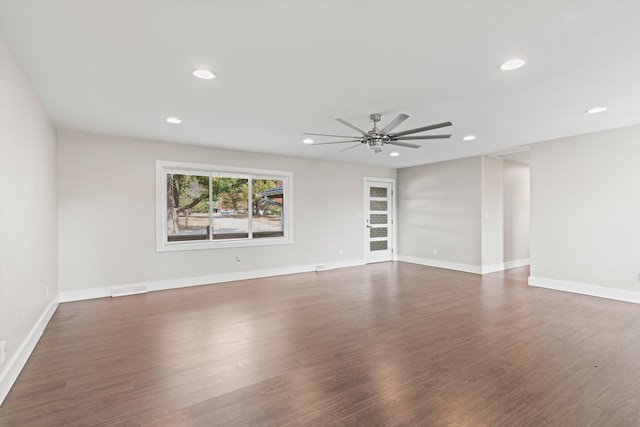 empty room featuring ceiling fan and dark hardwood / wood-style flooring