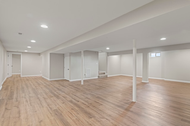 basement with light hardwood / wood-style flooring