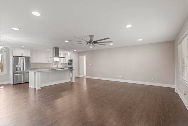 unfurnished living room with ceiling fan and dark hardwood / wood-style floors