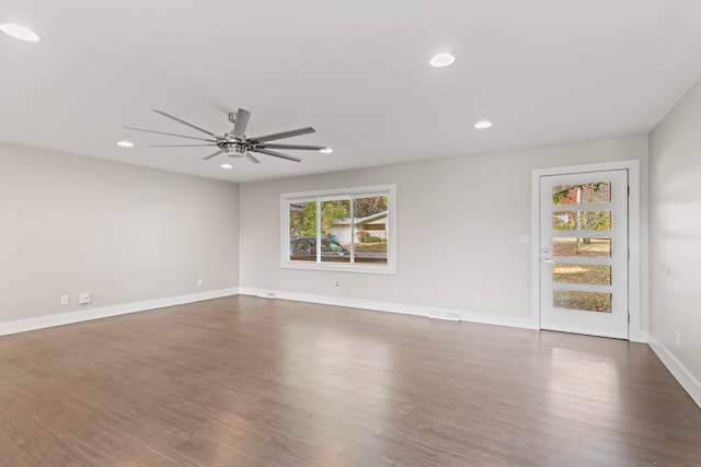 spare room with dark hardwood / wood-style floors and ceiling fan