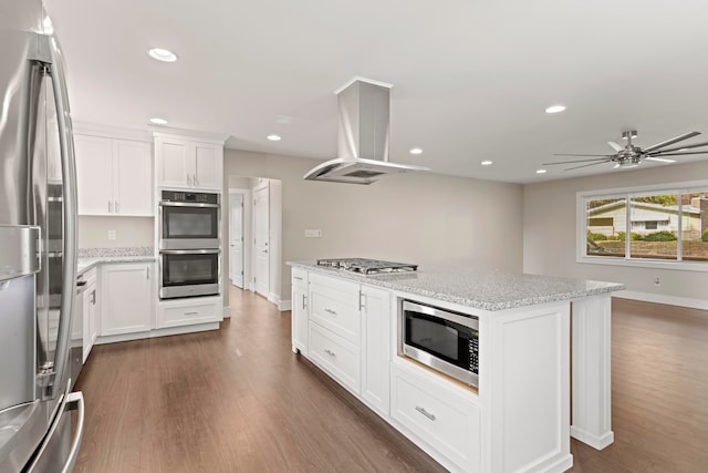 kitchen featuring island exhaust hood, appliances with stainless steel finishes, dark hardwood / wood-style flooring, and white cabinets