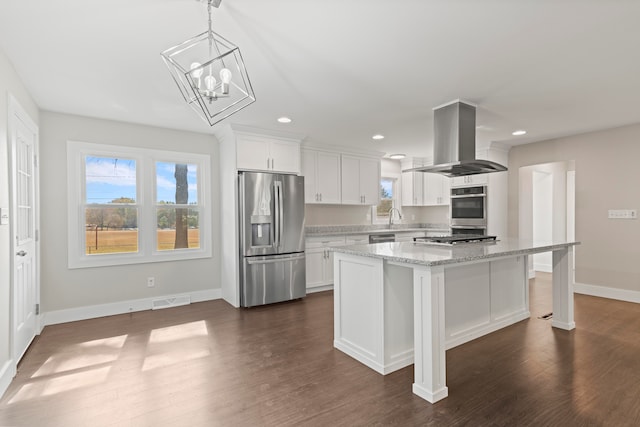 kitchen with appliances with stainless steel finishes, a kitchen island, island exhaust hood, white cabinets, and dark hardwood / wood-style floors